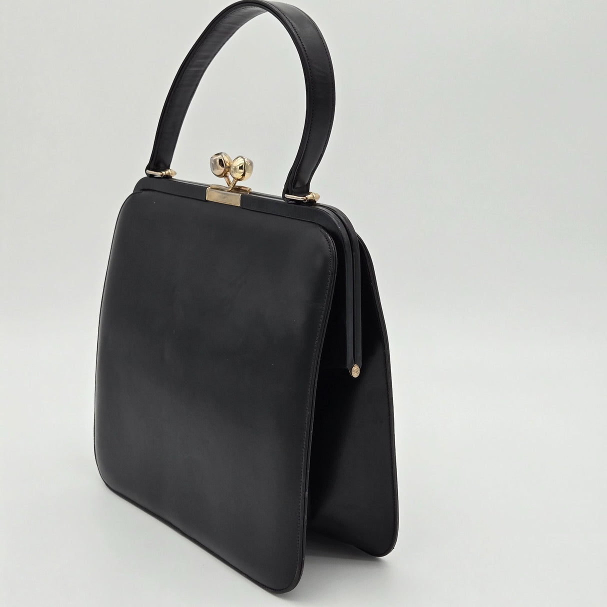Vintage Black Leather Handbag By Bags By Supreme With Gold Kiss Lock Closure & Genuine Leather Lining